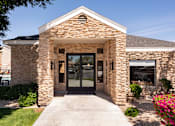 Thumbnail 3 of 36 - the front entrance of a brick building with glass doors