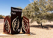 Thumbnail 32 of 36 - a sign for thunderbird park on the side of a road