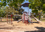 Thumbnail 33 of 36 - a playground with a assortment of playground equipment in a park