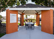 Thumbnail 25 of 36 - a patio with a table and chairs under a gazebo