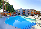 Thumbnail 24 of 36 - a swimming pool at the resort with apartments in the background