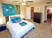 Thumbnail 7 of 25 - a bedroom with a bed and a ceiling fan