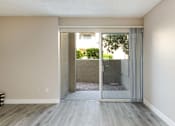 Thumbnail 11 of 25 - living room with sliding glass doors to an outdoor patio