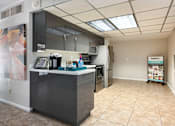 Thumbnail 20 of 25 - a kitchen with a counter and a refrigerator