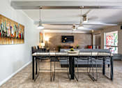 Thumbnail 18 of 25 - a dining room with a table and chairs