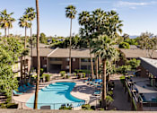 Thumbnail 12 of 25 - an aerial view of a resort with a swimming pool and palm trees