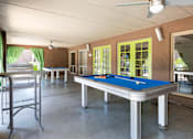 Thumbnail 16 of 25 - a game room with a pool table and a bar