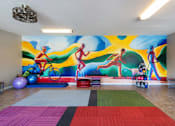 Thumbnail 23 of 25 - a wall mural in a room with a gym and exercise equipment