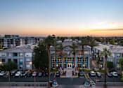 Thumbnail 8 of 42 - A hotel with a parking lot in front of it.