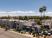 Thumbnail 23 of 23 - an aerial view of a row of apartment buildings and palm trees