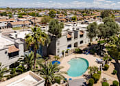 Thumbnail 22 of 23 - an aerial view of a community with a pool and palm trees