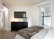 Thumbnail 13 of 23 - the preserve at ballantyne commons bedroom with large bed and tv