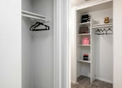 Thumbnail 15 of 23 - a walk in closet with shelves and a hanger on the wall