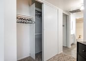 Thumbnail 16 of 23 - a walk in closet in a bedroom with a mirrored closet door