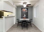 Thumbnail 5 of 23 - a dining room with a table and chairs and a ceiling fan