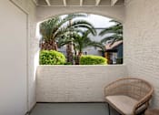 Thumbnail 17 of 23 - a balcony with a chair and palm trees