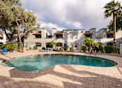 Thumbnail 21 of 23 - a swimming pool with a house in the background