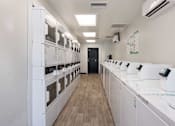 Thumbnail 18 of 23 - a white room with a row of microwaves on the counters