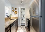Thumbnail 2 of 35 - a kitchen with stainless steel appliances and granite counter tops