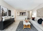 Thumbnail 5 of 35 - a living room with a white couch and a coffee table