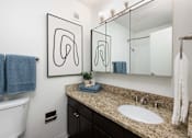 Thumbnail 15 of 35 - a bathroom with a large mirror and a sink