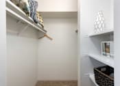 Thumbnail 14 of 33 - a walk in closet with shelves and a closet door with a mirror