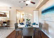 Thumbnail 5 of 33 - a dining room with a table and chairs and a ceiling fan