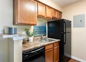 Thumbnail 9 of 33 - a kitchen with a black refrigerator and a sink