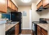 Thumbnail 8 of 33 - a kitchen with black appliances and granite counter tops