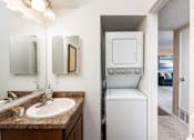 Thumbnail 15 of 33 - a bathroom with a sink and a washer and dryer