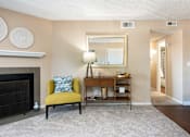 Thumbnail 4 of 33 - a living room with a fireplace and a yellow chair