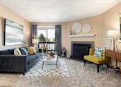 Thumbnail 1 of 33 - a living room with a blue couch and a fireplace