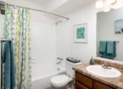 Thumbnail 24 of 33 - a bathroom with a shower and a toilet and a sink