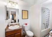 Thumbnail 13 of 33 - a bathroom with a shower toilet and sink and a mirror