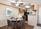 Thumbnail 20 of 33 - an open kitchen and dining room with a table and chairs