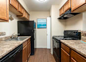 Thumbnail 21 of 33 - a kitchen with granite counter tops and black appliances