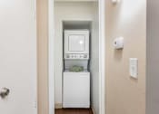 Thumbnail 25 of 33 - a small laundry room with a washer and dryer in it