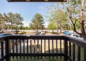 Thumbnail 16 of 33 - a view from a deck of cars parked in a parking lot