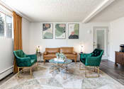 Thumbnail 1 of 35 - a living room with two green chairs and a brown couch