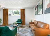 Thumbnail 3 of 35 - a living room with brown leather furniture and green chairs