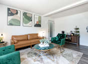 Thumbnail 2 of 35 - a living room with green chairs and a brown couch