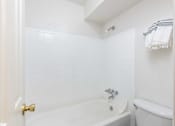 Thumbnail 9 of 35 - a white bathroom with a tub and a toilet