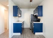 Thumbnail 14 of 35 - Kitchen with navy cabinets and a black refrigerator