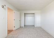 Thumbnail 19 of 35 - an empty bedroom with a closet and a door to a wardrobe