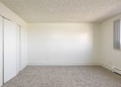 Thumbnail 18 of 35 - an empty room with white walls and a window and a closet