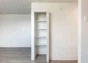 Thumbnail 17 of 35 - an empty closet in a room with white walls and wood floors