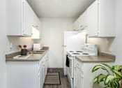 Thumbnail 5 of 35 - a kitchen with white appliances and counters and white cabinets