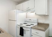 Thumbnail 6 of 35 - a kitchen with white appliances and white cabinets and a white refrigerator