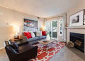Thumbnail 2 of 16 - a living room with a couch and a coffee table and a fireplace