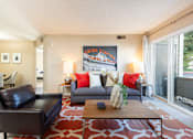 Thumbnail 1 of 16 - a living room with a couch and a coffee table